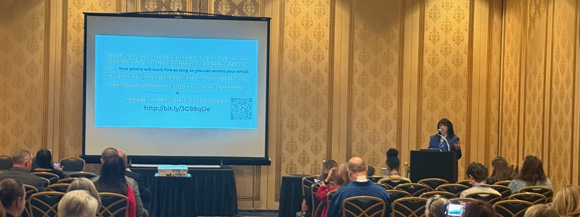 Charlena Miller presenting to a room of faculty and staff at a conference session